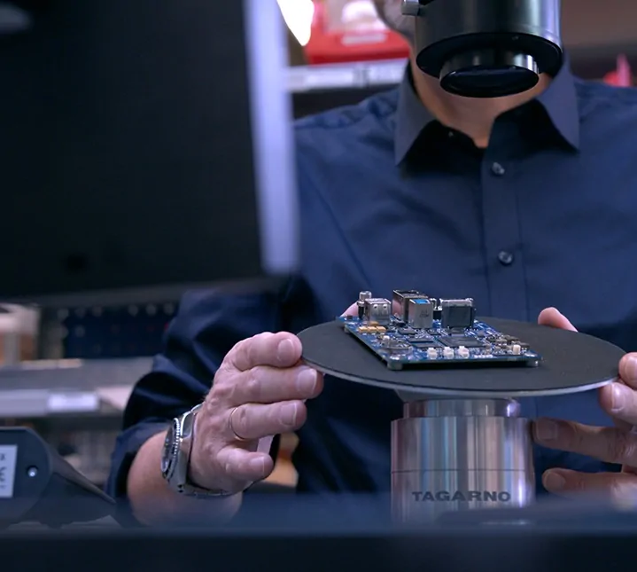 Man using a digital microscope to inspect PCB
