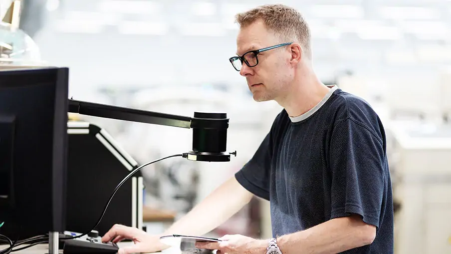 Man using a microscope with a camera from TAGARNO