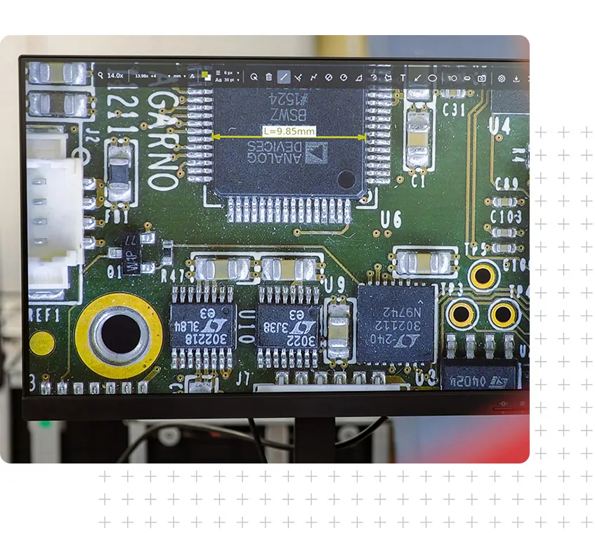 Monitor with live image from a digital microscope using software to perform quality control on a PCBA
